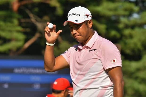 Japan's Hideki Matsuyama reacts after finishing round 3 of the Olympic golf tournament, where he's one shot back of leader Xander Schauffele. (Kazuhiro Nogi/AFP via Getty Images - image credit)