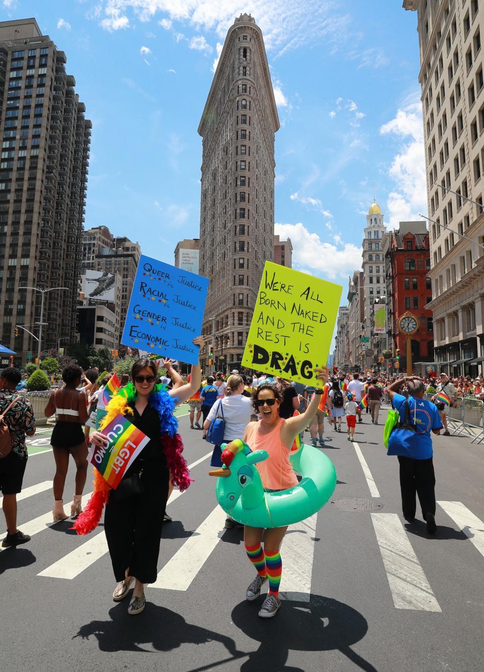 <p>Marchers hold up signs during the N.Y.C. Pride Parade in New York on June 25, 2017. (Photo: Gordon Donovan/Yahoo News) </p>