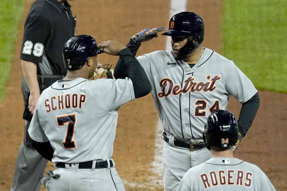 Detroit Tigers' Miguel Cabrera (24) celebrates with Jonathan Schoop (7) after hitting a grand slam during the seventh inning of a baseball game against the Kansas City Royals Friday, May 21, 2021, in Kansas City, Mo. (AP Photo/Charlie Riedel)