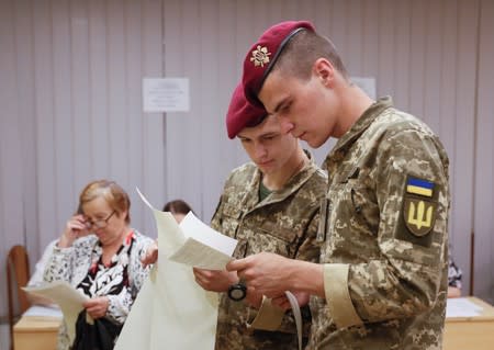 Ukrainian servicemen visit a polling station during a parliamentary election in Kiev