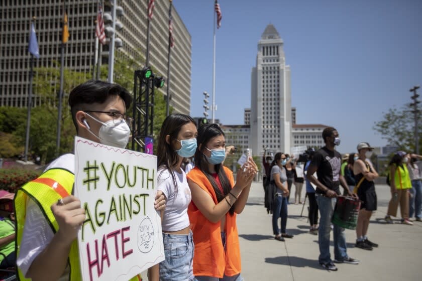 LOS ANGELES, CA - MAY 08: Calvin Truong, 15, left-right, Bailey Nguyen, 15, and Leanna Luu, 15, are participating in a Youth Against Hate rally for a solidarity in light of anti-Asian violence and hate crimes on Saturday, May 8, 2021 in Los Angeles, CA. (Francine Orr / Los Angeles Times)