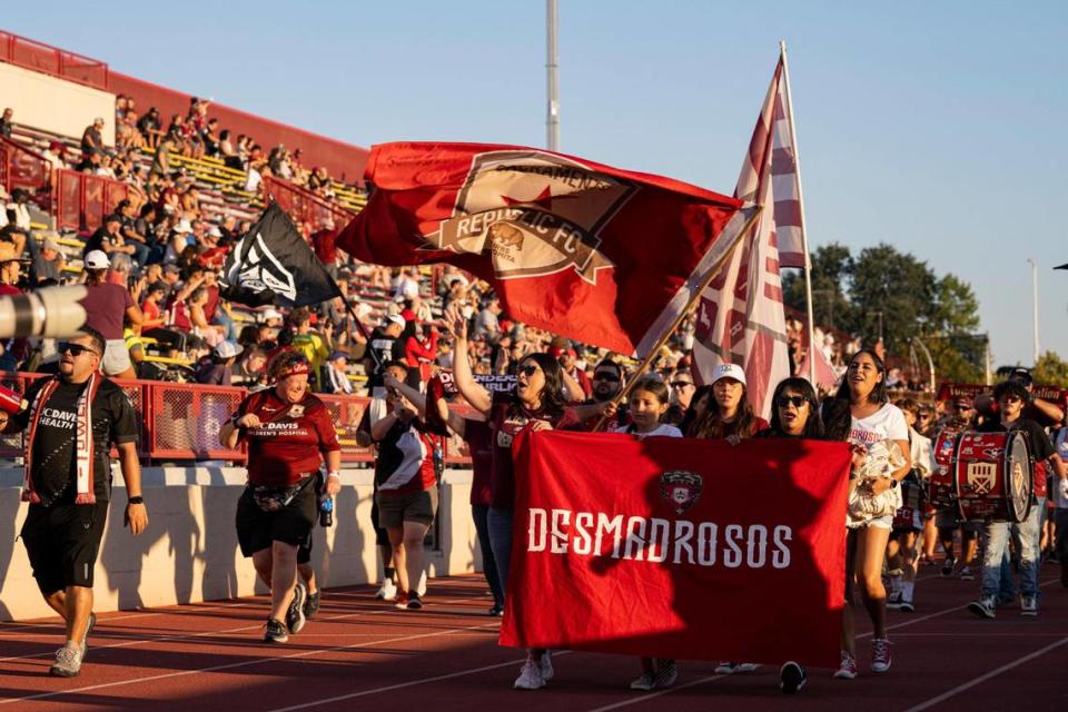 The Tower Bridge Battalion, a supporter union, leads the march from into Hughes Stadium for the USL soccer game between Sacramento Republic FC and Orange County SC on Saturday. Republic FC returned to the site of its first match for a 10th-season celebration.