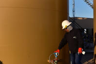 Carlos Riojas checks pressure levels at a wastewater injection facility operated by On Point Energy in Big Spring, Texas U.S. February 12, 2019. Picture taken February 12, 2019. REUTERS/Nick Oxford