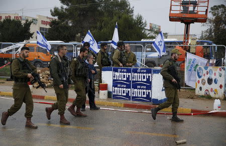 Israeli soldiers patrol the scene where Israeli security forces shot dead a Palestinian assailant who tried to stab a man at Gush Etzion junction, near a West Bank settlement on Tuesday, police said, a location that has seen many attacks during two months of violence. December 1, 2015. REUTERS/Baz Ratner