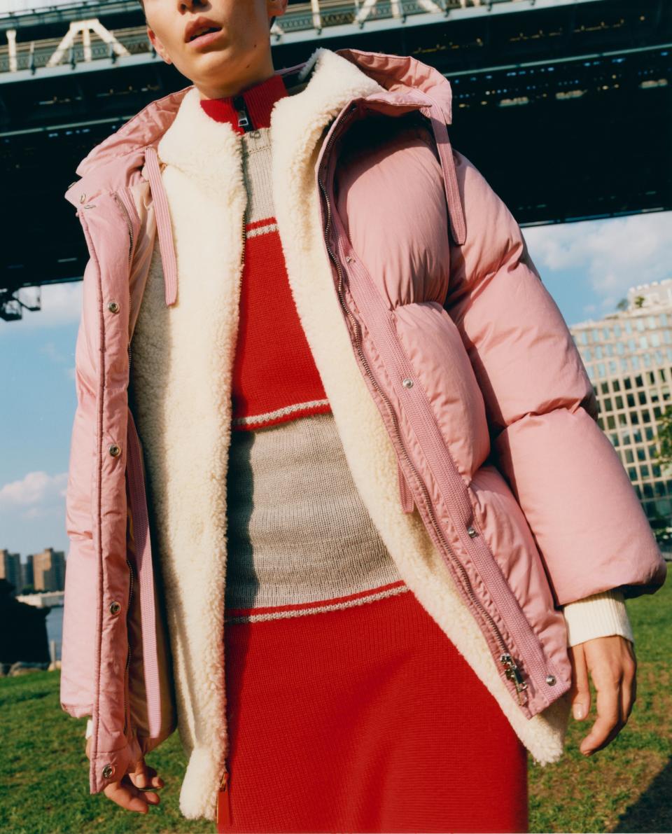 Cleo Cwiek takes a stroll around Brooklyn in a tonal look, pairing her red and beige sweaterdress with a cotton candy pink <a rel="nofollow noopener" href="https://weallwear.moncler.com/" target="_blank" data-ylk="slk:Moncler Nerium jacket;elm:context_link;itc:0;sec:content-canvas" class="link ">Moncler Nerium jacket</a>, $1,810