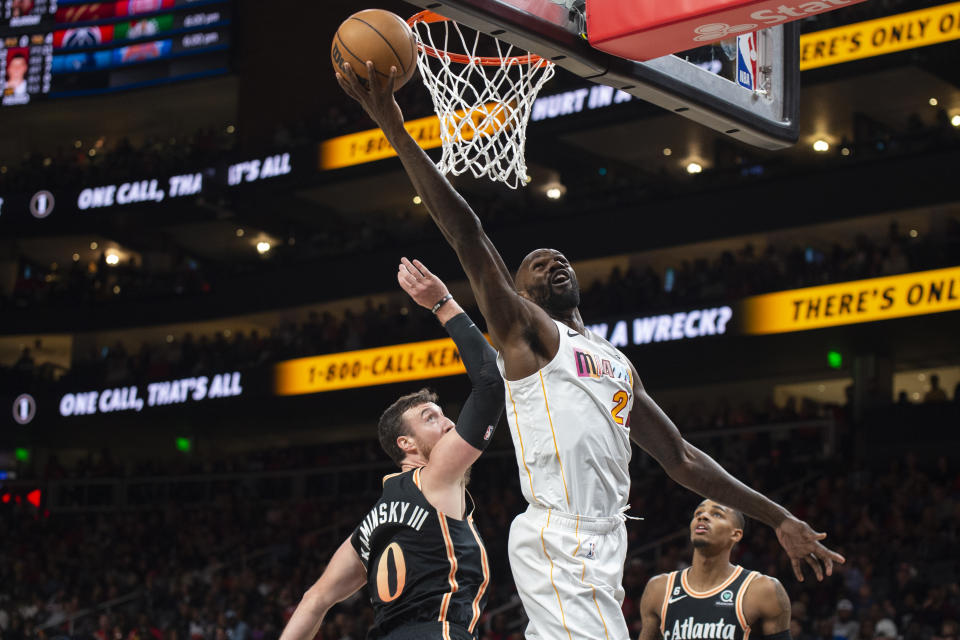 Miami Heat center Dewayne Dedmon scores against Atlanta Hawks forward Frank Kaminsky during the second half of an NBA basketball game, Sunday, Nov. 27, 2022, in Atlanta. (AP Photo/Hakim Wright Sr.)