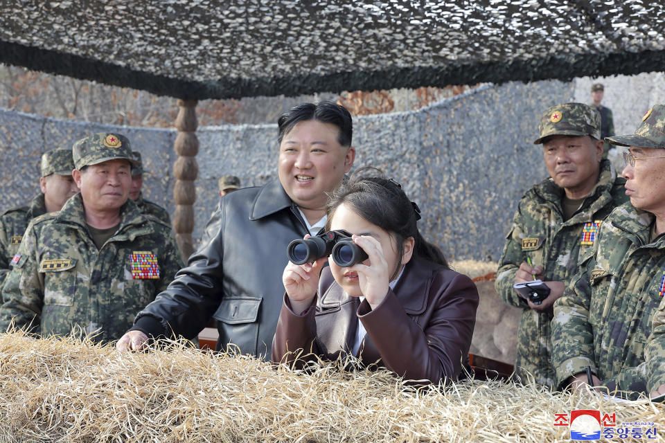 In this photo provided by the North Korean government, North Korean leader Kim Jong Un, center left, and his daughter inspect a training of the Korean People's Army airborne units in North Korea Friday, March 15, 2024. Independent journalists were not given access to cover the event depicted in this image distributed by the North Korean government. The content of this image is as provided and cannot be independently verified. Korean language watermark on image as provided by source reads: "KCNA" which is the abbreviation for Korean Central News Agency. (Korean Central News Agency/Korea News Service via AP)