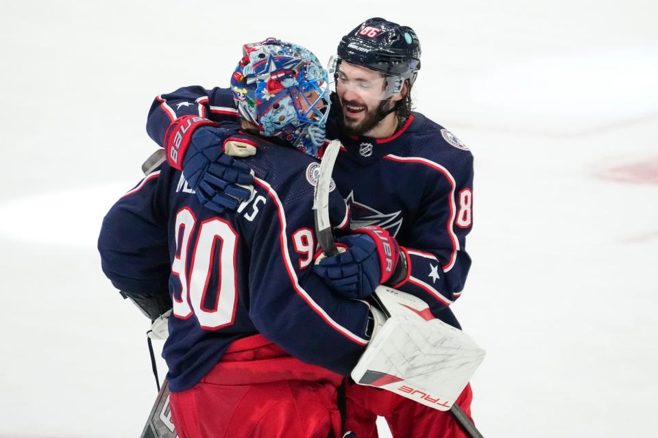 Jan 15, 2024; Columbus, Ohio, USA; Columbus Blue Jackets goaltender Elvis Merzlikins (90) celebrates with right wing Kirill Marchenko (86) following the shootout in the NHL hockey game against the Vancouver Canucks at Nationwide Arena. The Blue Jackets won 4-3.