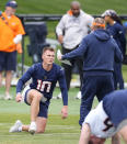 Denver Broncos quarterback Bo Nix, center left, confers with head coach Sean Payton, center right, during an NFL football rookie minicamp practice Saturday, May 11, 2024, in Centennial, Colo. (AP Photo/David Zalubowski)