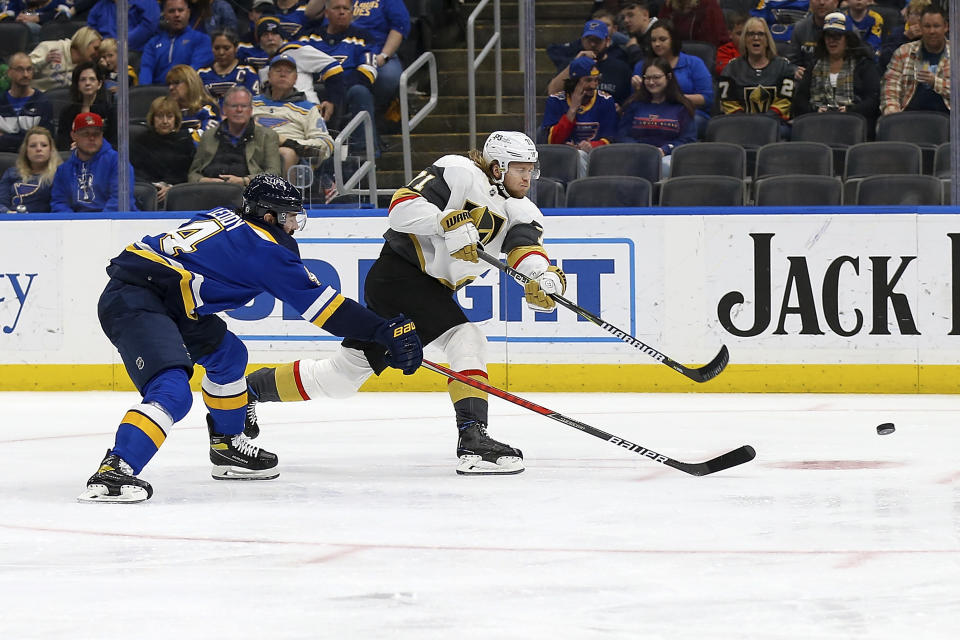 Vegas Golden Knights' William Karlsson (71) shoots the puck and scores a goal while under pressure from St. Louis Blues' Nick Leddy (4) during the third period of an NHL hockey game Friday, April 29, 2022, in St. Louis. (AP Photo/Scott Kane)