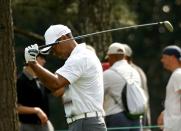 Tiger Woods of the U.S. reacts after taking his second shot on the ninth hole from the first fairway during first round play of the Masters golf tournament at the Augusta National Golf Course in Augusta, Georgia April 9, 2015. REUTERS/Mark Blinch