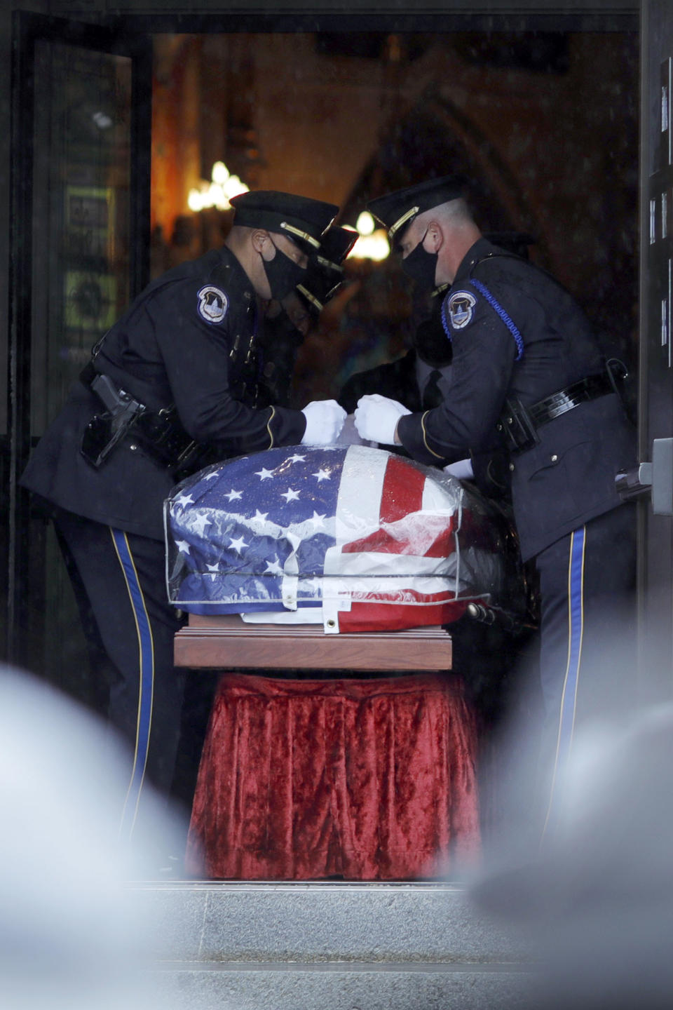 Capitol Police Officers carry the casket of their fellow officer, the late William "Billy" Evans into St. Stanislaus Kotska Church in Adams, Mass., for his funeral on Thursday, April 15, 2021. Evans was killed this month when a driver struck him and another officer at a barricade outside the Senate. (Stephanie Zollshan/The Berkshire Eagle via AP)