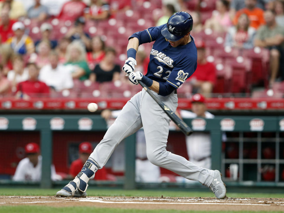 Milwaukee Brewers' Christian Yelich singles off Cincinnati Reds starting pitcher Matt Harvey during the first inning of a baseball game, Wednesday, Aug. 29, 2018, in Cincinnati. (AP Photo/Gary Landers)