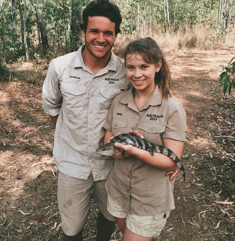 Chandler Powell and Bindi Irwin hold Australian lizard in the iconic Steve Irwin khaki on the croc tour in 2016