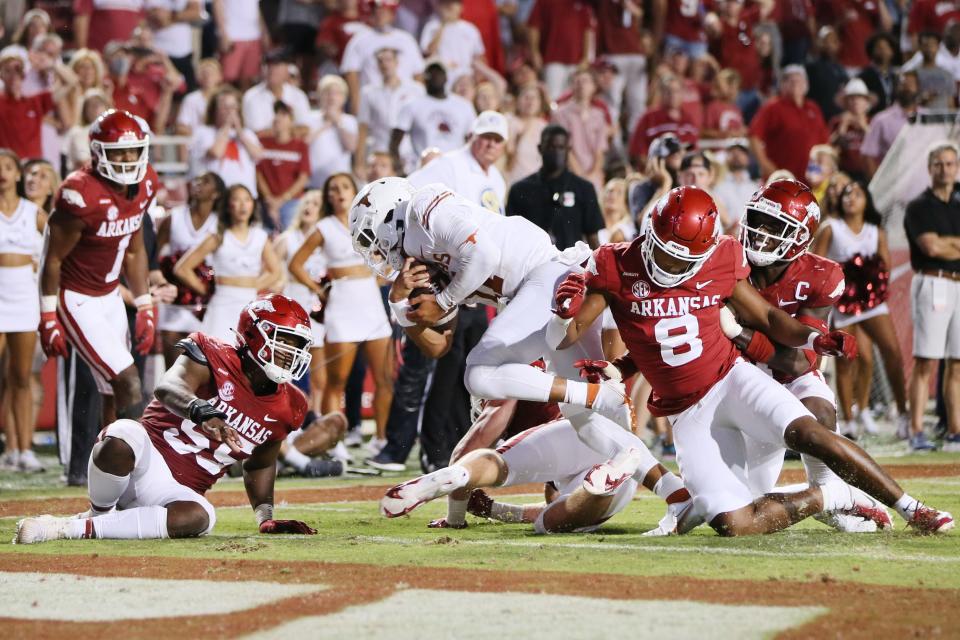 Texas quarterback Casey Thompson scores a fourth-quarter touchdown in the Longhorns' 40-21 loss to Arkansas in 2021 at Razorback Stadium in Fayetteville. The two teams will do it all over again when Texas joins the SEC in 2024.