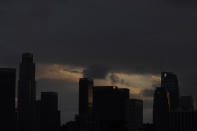 Heavy clouds move over downtown Los Angeles, Monday, Dec. 13, 2021. The storm will bring much-needed moisture to the broader region that's been gripped by drought that scientists have said is caused by climate change. The latest U.S. drought monitor shows parts of Montana, Oregon, California, Nevada and Utah are classified as being in exceptional drought, which is the worst category. (AP Photo/Damian Dovarganes)