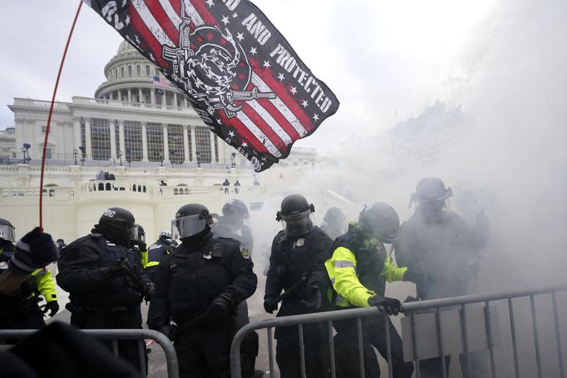 In this Jan. 6, 2021, U.S. Capitol Police officers hold off rioters loyal to President Donald Trump at the Capitol in Washington. (AP Photo/Julio Cortez, File)