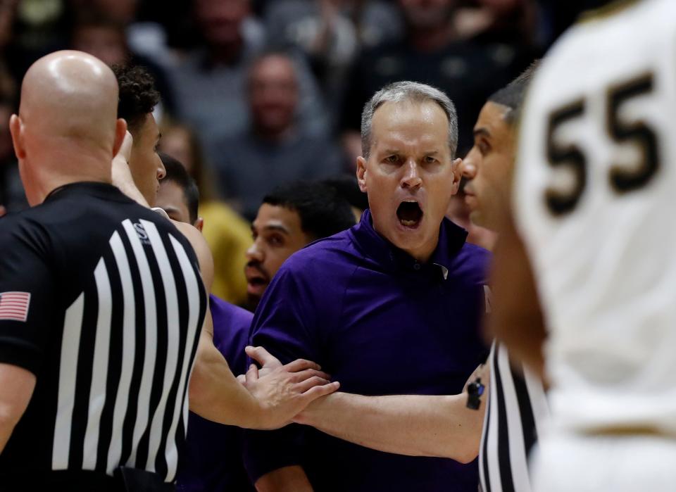 Northwestern Wildcats head coach Chris Collins is held back by Northwestern Wildcats players during the NCAA men’s basketball game against the <a class="link " href="https://sports.yahoo.com/ncaaf/teams/purdue/" data-i13n="sec:content-canvas;subsec:anchor_text;elm:context_link" data-ylk="slk:Purdue Boilermakers;sec:content-canvas;subsec:anchor_text;elm:context_link;itc:0">Purdue Boilermakers</a>, Wednesday, Jan. 31, 2024, at Mackey Arena in West Lafayette, Ind. Purdue Boilermakers 105-96.