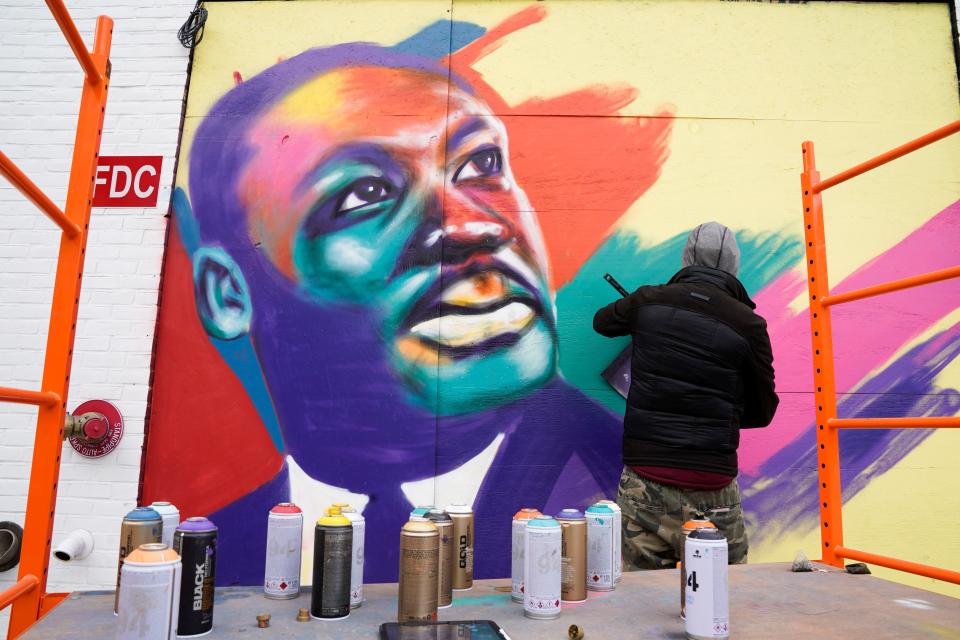 Jan 18, 2021; Washington, DC, USA; Levi Robinson and members of The P.A.I.N.T.S. Institute work on a mural featuring Dr. Martin Luther King Jr. on 5th and K Streets on Jan. 18, 2021 in Washington, D.C. The nation's capital is still on high-alert with heightened security against threats to President-elect Joe Biden’s inauguration following the deadly pro-Trump insurrection. Mandatory Credit: Jarrad Henderson-USA TODAY ORG XMIT: USATODAY-446402 [Via MerlinFTP Drop]