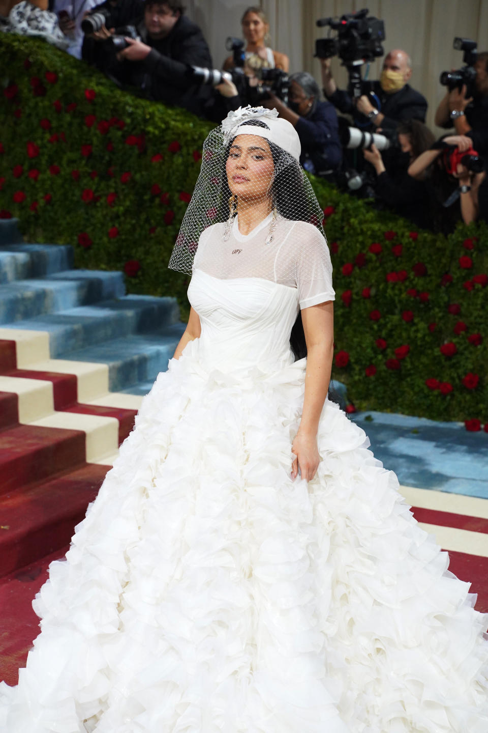 Kylie wears a wedding dress and veil