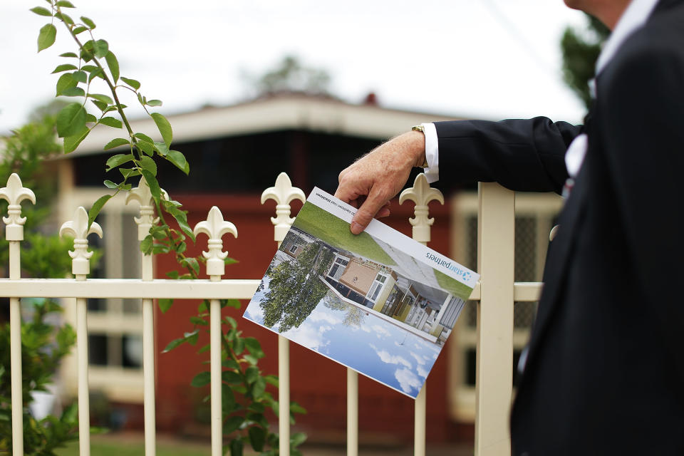 BLACKTOWN, AUSTRALIA - FEBRUARY 14:  A prospective buyer looks at a property before the home auction for a four-bedroom house at 230 Blacktown Road on February 14, 2015 in Blacktown, Australia. The Blacktown home sold for AUD$565,000 at auction today, smashing the reserve set at AUD$1. The Sydney home auction clearance rate is expected to remain high following the Reserve Bank's interest rate cut to 2.25 per cent last week.  (Photo by Mark Metcalfe/Getty Images)
