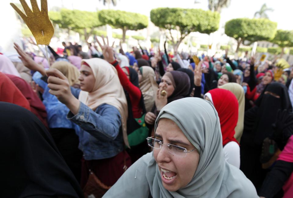 Cairo University students and members of the Muslim Brotherhood shout slogans against the military and interior ministry inside Cairo University