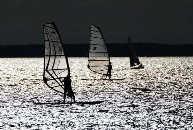 Sailors and windsurfers play in the winds on the Ottawa River in Ottawa in late July. (Sean Kilpatrick/Canadian Press - image credit)