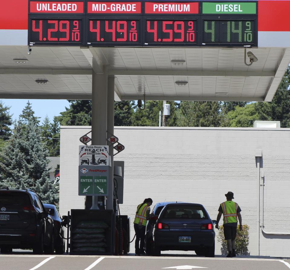 Attendants in vests service cars at a gas station in Salem, Oregon, on Thursday, June 22, 2023. In 1951, Oregon banned self-serve pumps at filling stations, being the only U.S. state besides New Jersey to do so. But now, the Oregon Legislature has decided that people across the state should be able to choose between having an attendant pump the gas or do it themselves. Gov. Tina Kotek signed the bill into law on Friday, Aug. 4, 2023, taking effect immediately. (AP Photo/Andrew Selsky)