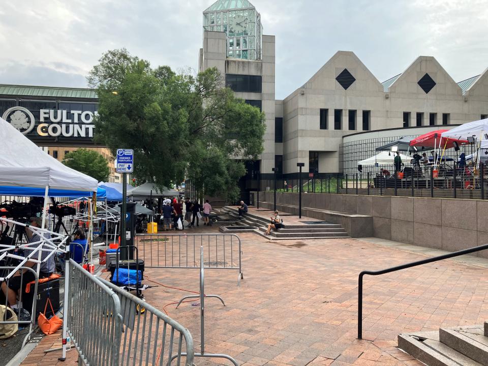 Media found tent spaces along the road, on the sidewalk and in the courtyard of an adjacent building as they continued watching the Lewis R. Slaton Courthouse on Tuesday