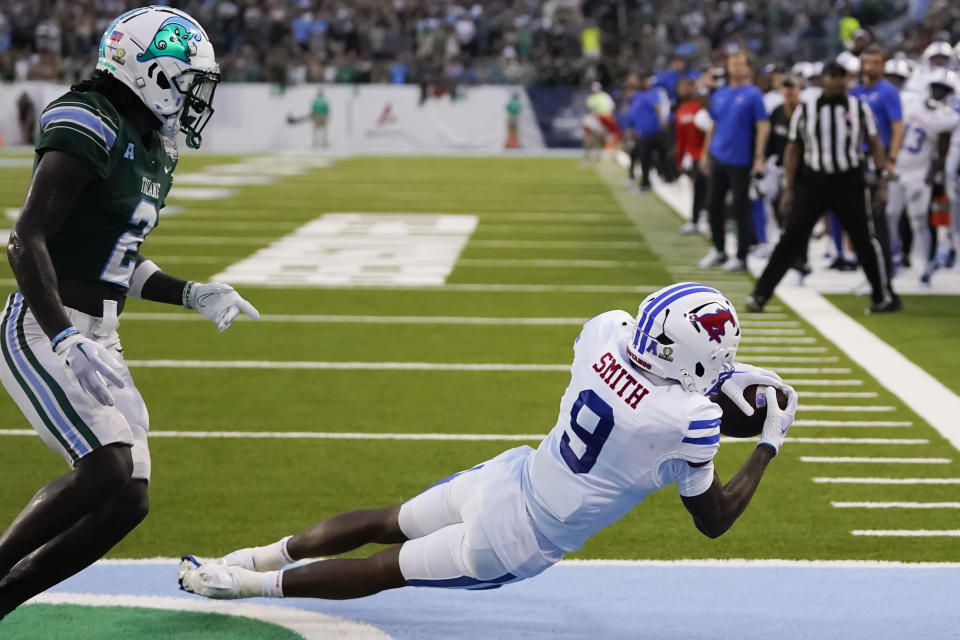 SMU wide receiver Key'Shawn Smith (9) pulls in a touchdown reception against Tulane defensive back Jarius Monroe (2) during the first half of the American Athletic Conference Championship NCAA college football game, Saturday, Dec. 2, 2023 in New Orleans. (AP Photo/Gerald Herbert)