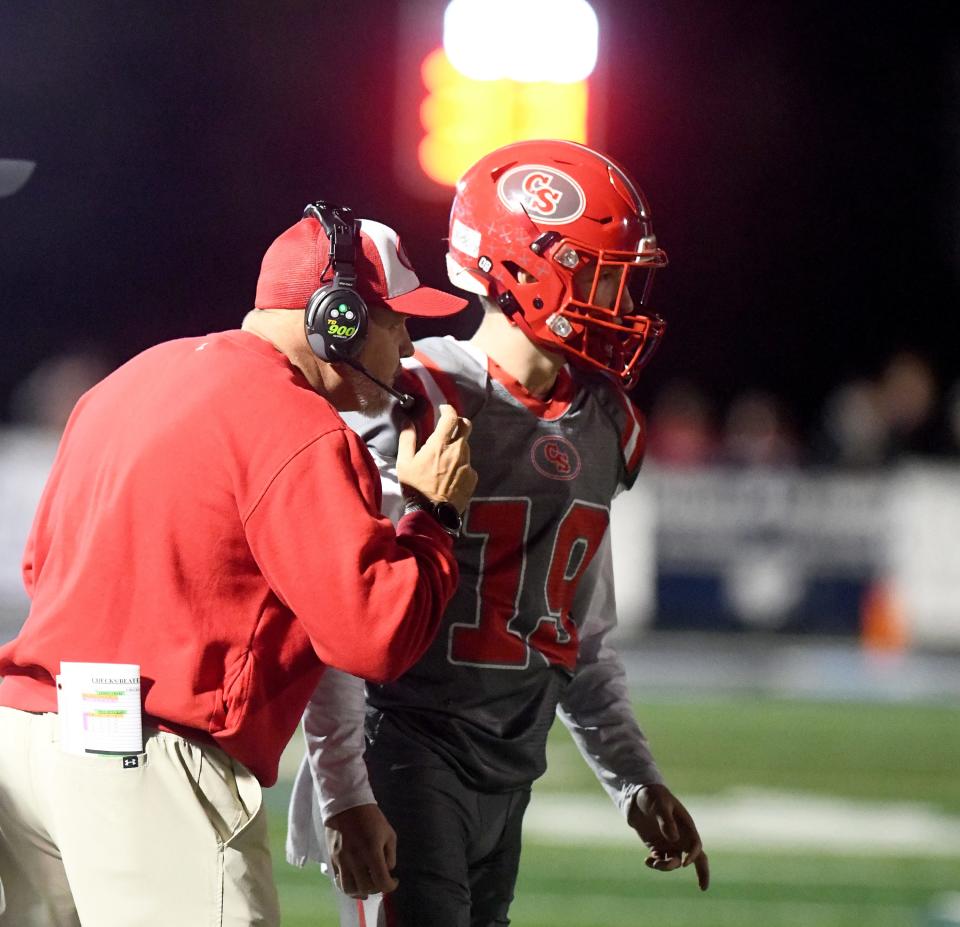 Canton South head coach Matt Dennison talks to quarterback Poochie Snyder in the first quarter of Division IV regional semifinal against West Branch at Louisville Leopard Stadium. Friday, Nov. 10, 2023.