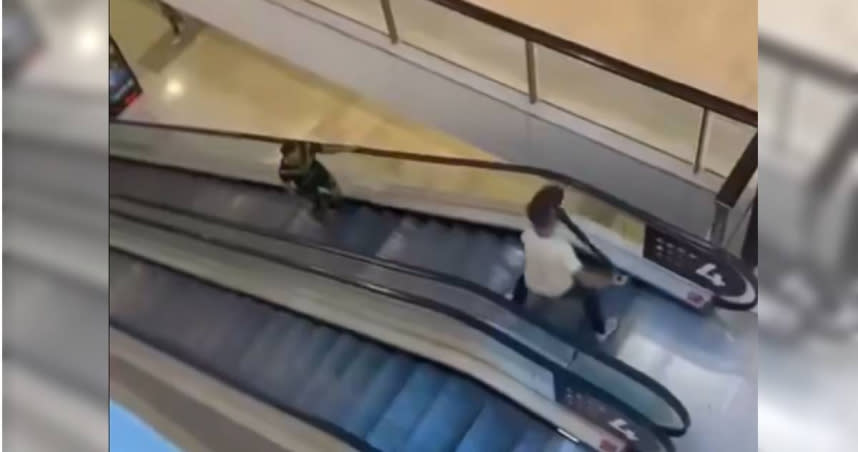 雪梨一間大型商場13日下午發生持刀攻擊事件，事發當時，一名白衣男子手持紅龍柱，孤身守在電扶梯頂端與兇手對峙，阻止他傷害更多民眾。（圖／翻攝X／Usman Chaudhary）