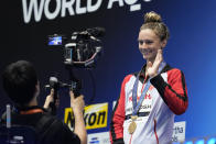 Gold medalist Summer McIntosh of Canada waves at the camera during the medal ceremony for the women's 400m medley at the World Swimming Championships in Fukuoka, Japan, Sunday, July 30, 2023. (AP Photo/Eugene Hoshiko)