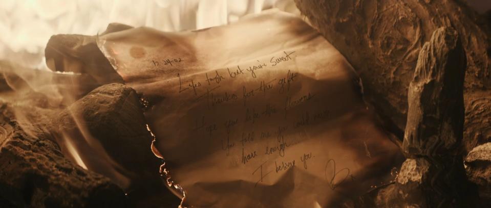 A burned letter in "This Is Me... Now: A Love Story."