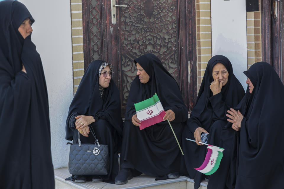 Iranian citizens gather to cast their votes during the presidential election at the Iranian consulate in Basra southeast of Baghdad, Iraq, Friday, June 28, 2024. Iranians are voting in a presidential election to replace the late President Ebrahim Raisi, killed in a helicopter crash in May along with the country's foreign minister and several other officials. (AP Photo/Nabil al-Jourani)