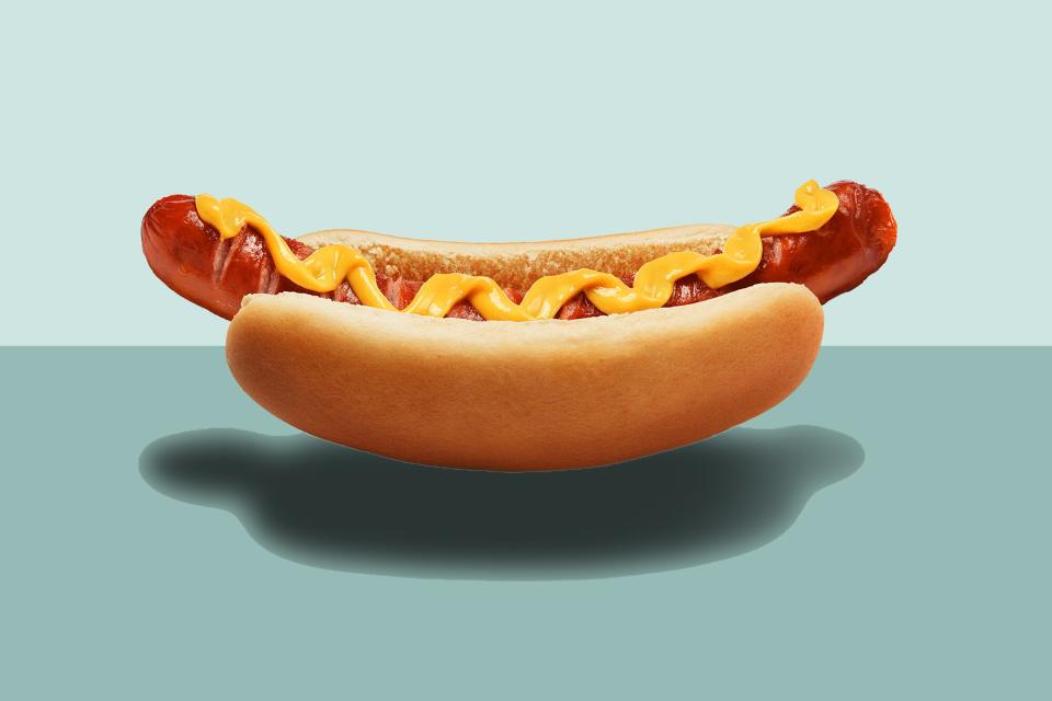 a photo of a floating hot dog with mustard on top