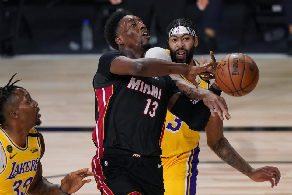 Los Angeles Lakers' Anthony Davis, right, stops Miami Heat's Bam Adebayo (13) on a drive to the basket during the first half of Game 1 of basketball's NBA Finals Wednesday, Sept. 30, 2020, in Lake Buena Vista, Fla. (AP Photo/Mark J. Terrill)