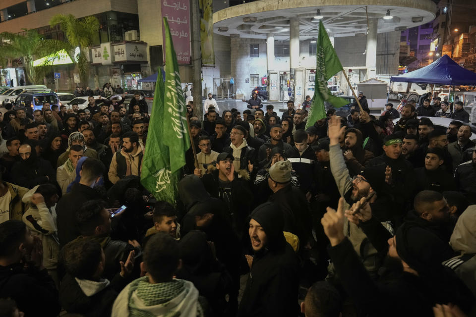 Palestinian demonstrators wave Hamas flags and shout slogans during a protest following the killing of top Hamas official Saleh Arouri in Beirut, in the West Bank city of Nablus on Tuesday, Jan. 2, 2024. Arouri, the No. 2 figure in Hamas, was killed in an explosion blamed on Israel. He is the highest-ranked Hamas figure to be killed in the nearly three-month war between Israel and Hamas. (AP Photo/Majdi Mohammed)