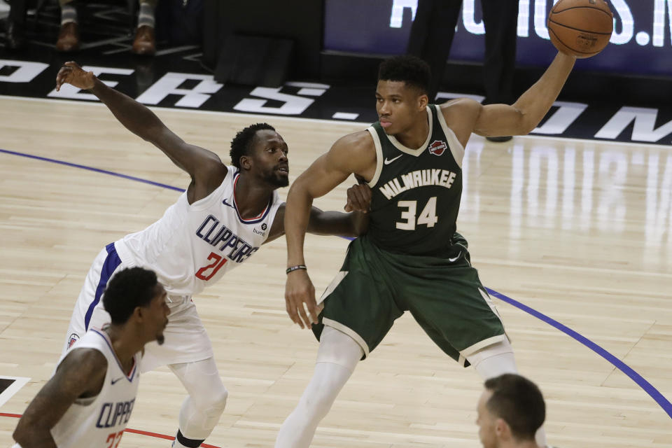 Milwaukee Bucks' Giannis Antetokounmpo (34) is defended by Los Angeles Clippers' Patrick Beverley (21) during the first half of an NBA basketball game Wednesday, Nov. 6, 2019, in Los Angeles. (AP Photo/Marcio Jose Sanchez)