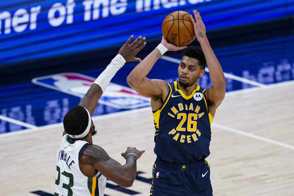 Indiana Pacers guard Jeremy Lamb (26) shoots over Utah Jazz forward Royce O'Neale (23) during the second half of an NBA basketball game in Indianapolis, Sunday, Feb. 7, 2021. (AP Photo/Michael Conroy)