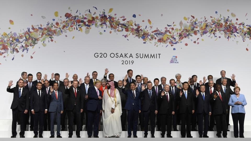 FILE - In this June 28, 2019, file photo, U.S. President Donald Trump talks with Saudi Arabia's Crown Prince Mohammed bin Salman during a group photo at the G-20 summit in Osaka, Japan. The Nov. 21-22, 2020, Group of 20 summit, hosted by Saudi Arabia, will be held online this year because of the coronavirus. The gathering of leaders of the world’s preeminent rich and developing nations will not be an opportunity for kings, presidents and prime ministers to conduct the intimate diplomacy of closed-door meetings or pose for memorable photo-ops. (AP Photo/Susan Walsh, File)