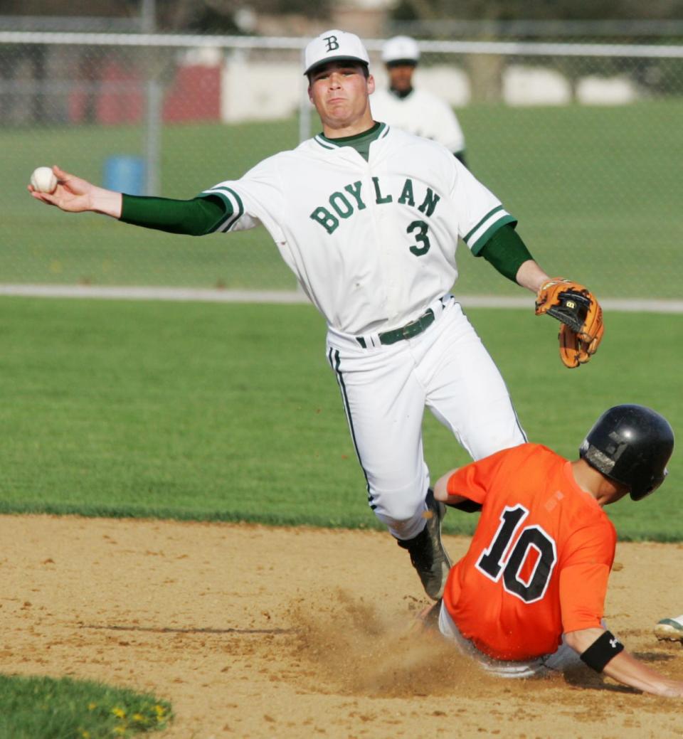 Boylan shortstop Jake Smolinski makes his throw despite the slide  by Harlem's Dan Kurich during his senior year at Boylan