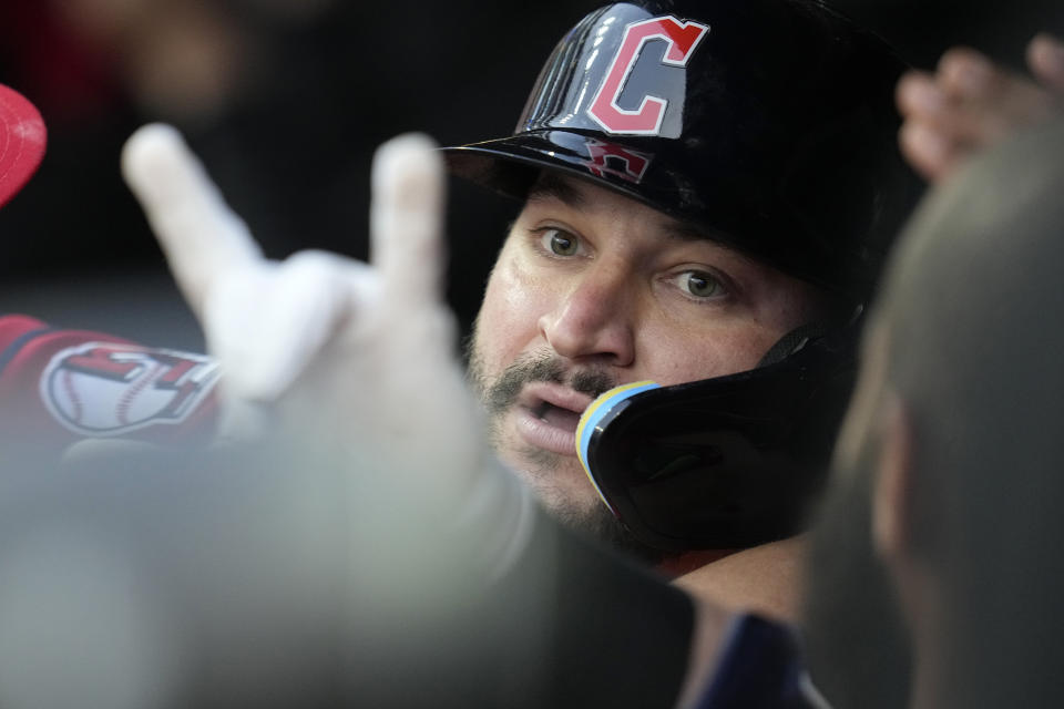 Cleveland Guardians' Mike Zunino is congratulated by teammates in the dugout after hitting a home run in the seventh inning of a baseball game against the Chicago White Sox, Monday, May 22, 2023, in Cleveland. (AP Photo/Sue Ogrocki)