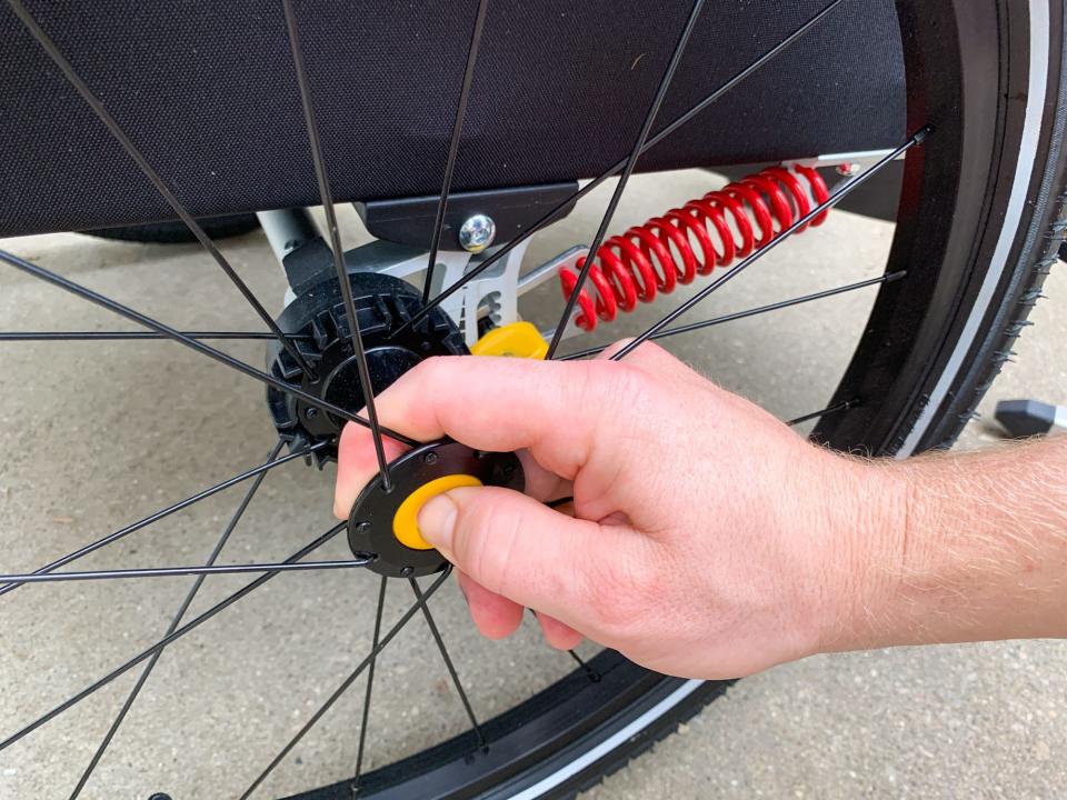 The wheels on Burley's D'Lite X are easily removed with the push of a button