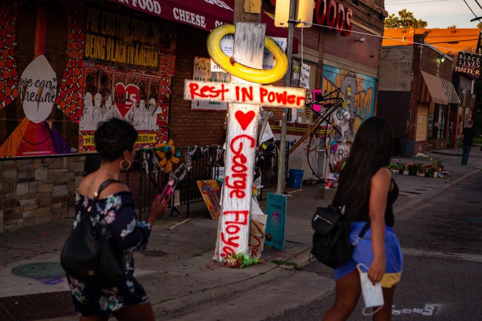 Visitors file past a makeshift memorial to George Floyd.