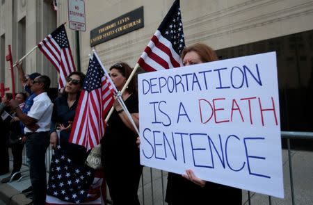 Protesters rally outside the federal court just before a hearing to consider a class-action lawsuit filed on behalf of Iraqi nationals facing deportation, in Detroit, Michigan, U.S., June 21, 2017. REUTERS/Rebecca Cook