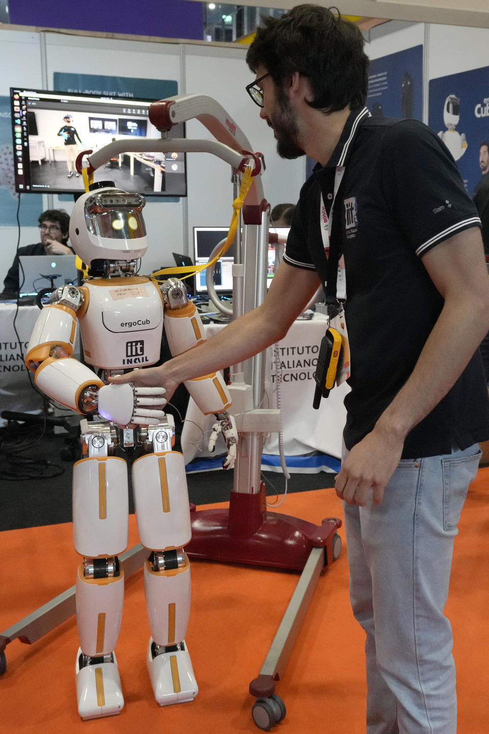 A robot from the Italian IIT interacts with visitors during the International Conference on Robotics and Automation ICRA in London, Tuesday, May 30, 2023. The 2023 ICRA brings together the world's top academics, researchers, and industry representatives to show the newest developments. (AP Photo/Frank Augstein)