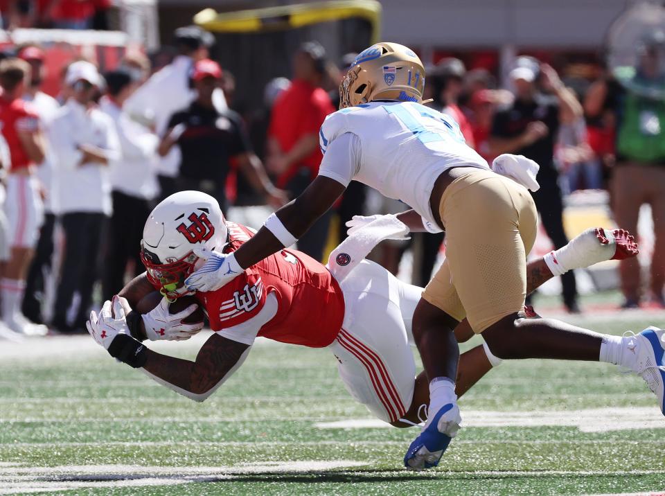 Utah Utes running back Ja’Quinden Jackson (3) dives for additional yardage against UCLA Bruins linebacker Jalen Woods (17) in Salt Lake City on Saturday, Sept. 23, 2023. | Jeffrey D. Allred, Deseret News