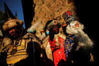 <p>Men dressed up as Gaspar, Balthasar and Melchior, the Three Wise Men, greet children during the traditional Epiphany parade in Malaga, southern Spain, Jan. 5, 2018. (Photo: Jon Nazca/Reuters) </p>