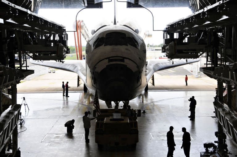 The space shuttle Atlantis is towed into its hangar at the Orbiter Processing Facility at Kennedy Space Center in Florida. The shuttle Atlantis cruised home for a final time Thursday, ending its last mission to the International Space Station and closing a 30-year chapter in American space exploration